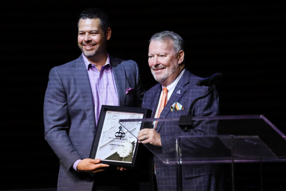 Orlando Mayor Buddy Dyer introduces Jarrod Dillon, the Downtowner of the Year for 2024, during the Downtown Orlando Partnership Golden Brick Awards, held at Steinmetz Hall in the Dr. Phillips Center for the Performing Arts on Wednesday, May 7, 2025. Jarrod Dillon, the President of Business Operations for Orlando City SC, Orlando Pride, and Inter&amp;Co Stadium, was recognized with the award, which honors an Orlando leader who has made a lasting impact on the success and vibrancy of downtown Orlando. (Rich Pope, Orlando Sentinel)